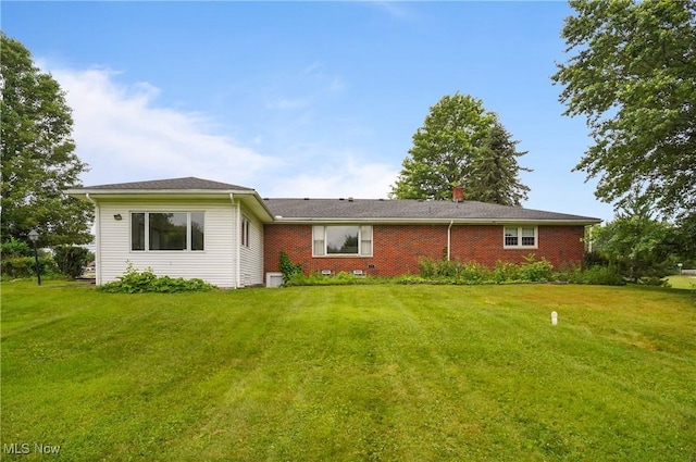 136 N Chillicothe Rd, Aurora, OH 44202 - rear view of house with a yard and brick siding