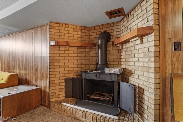 136 N Chillicothe Rd, Aurora, OH 44202 - detailed view of a wood stove, a textured ceiling, and wooden walls