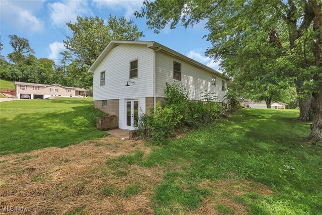 201 Hancock St, Woodsfield, OH 43793 - view of home's exterior featuring french doors and a lawn