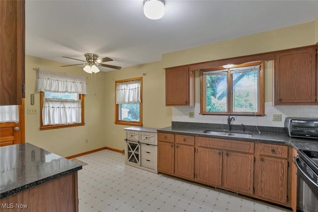 201 Hancock St, Woodsfield, OH 43793 - kitchen with ceiling fan, brown cabinetry, light flooring, and black range with electric stovetop