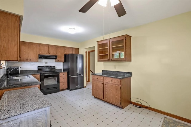 201 Hancock St, Woodsfield, OH 43793 - kitchen with freestanding refrigerator, black range with electric stovetop, under cabinet range hood, light floors, and brown cabinetry