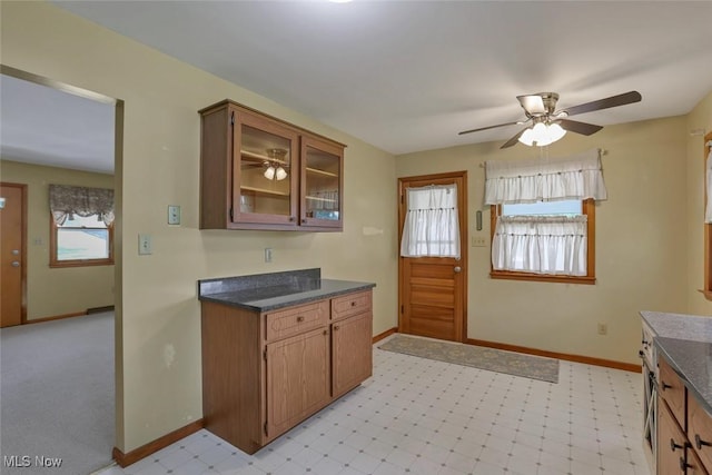 201 Hancock St, Woodsfield, OH 43793 - kitchen featuring plenty of natural light, a ceiling fan, dark countertops, and glass insert cabinets
