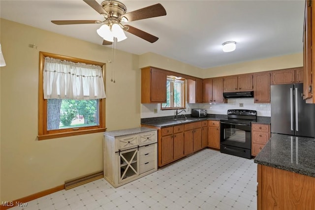 201 Hancock St, Woodsfield, OH 43793 - kitchen with black range with electric stovetop, freestanding refrigerator, under cabinet range hood, light floors, and ceiling fan