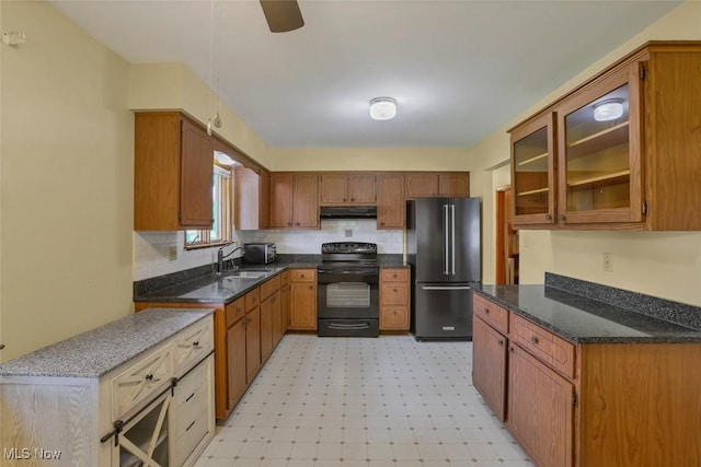 201 Hancock St, Woodsfield, OH 43793 - kitchen featuring black electric range oven, freestanding refrigerator, under cabinet range hood, light flooring, and brown cabinetry