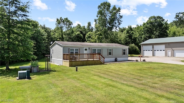 1467 Notman Rd, Deerfield, OH 44411 - manufactured / mobile home with a detached garage, a deck, a front yard, driveway, and an outbuilding