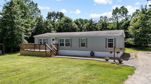 1467 Notman Rd, Deerfield, OH 44411 - manufactured / mobile home featuring a deck, a front yard, and driveway