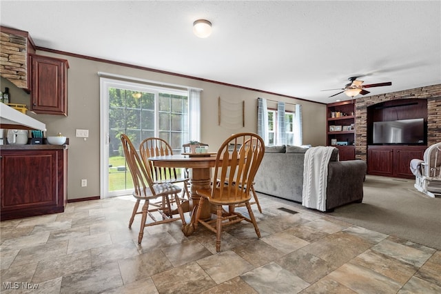 1467 Notman Rd, Deerfield, OH 44411 - dining area with crown molding, stone tile floors, ceiling fan, a textured ceiling, and built in shelves