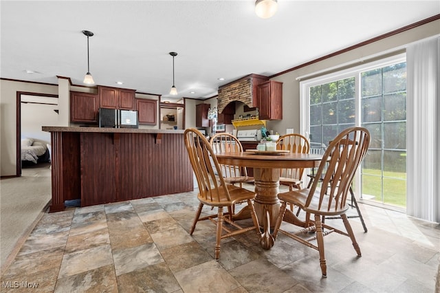 1467 Notman Rd, Deerfield, OH 44411 - dining space featuring ornamental molding and light stone finish flooring