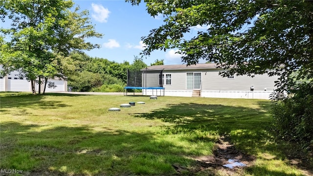 1467 Notman Rd, Deerfield, OH 44411 - view of grassy yard with a trampoline