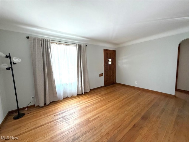 21571 Ball Ave, Euclid, OH 44123 - empty room with light wood-style floors and arched walkways