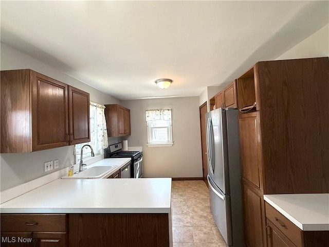 21571 Ball Ave, Euclid, OH 44123 - kitchen with appliances with stainless steel finishes, light countertops, a peninsula, and light tile patterned floors