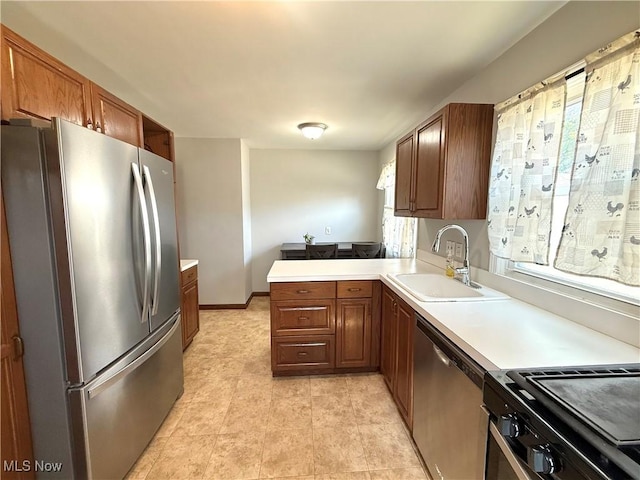 21571 Ball Ave, Euclid, OH 44123 - kitchen with stainless steel appliances, a peninsula, light countertops, and brown cabinets