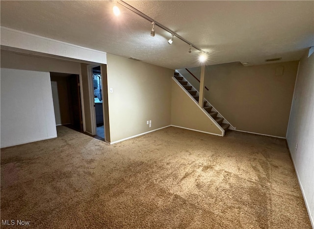 35049 N Turtle Trl Unit C, Willoughby, OH 44094 - finished below grade area featuring rail lighting, stairway, carpet floors, and a textured ceiling