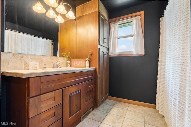 115 Coulter St, Creston, OH 44217 - full bath featuring double vanity, tile patterned flooring, a chandelier, and tasteful backsplash