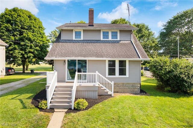 115 Coulter St, Creston, OH 44217 - view of front of property with a chimney, a front lawn, and a shingled roof