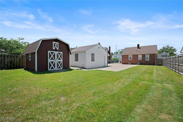 1835 Rockefeller Rd, Wickliffe, OH 44092 - back of property with a barn, an outdoor structure, a patio, and a fenced backyard