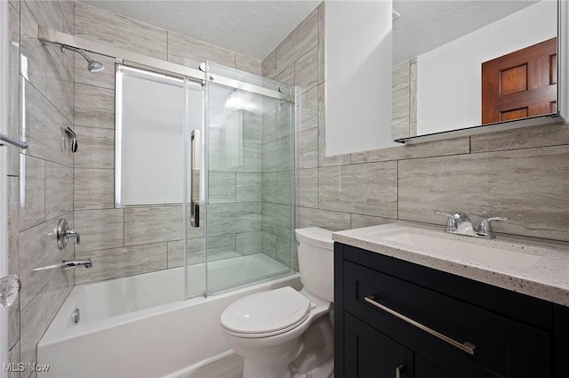 1835 Rockefeller Rd, Wickliffe, OH 44092 - bathroom featuring vanity, combined bath / shower with glass door, and tile walls