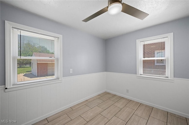1835 Rockefeller Rd, Wickliffe, OH 44092 - spare room with a ceiling fan, wainscoting, and wood finish floors