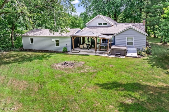6170 Oberlin Rd, Amherst, OH 44001 - rear view of house featuring a hot tub, a yard, a patio, and a chimney