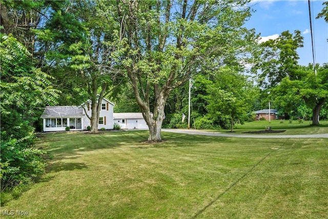 6170 Oberlin Rd, Amherst, OH 44001 - view of grassy yard with concrete driveway and an attached garage