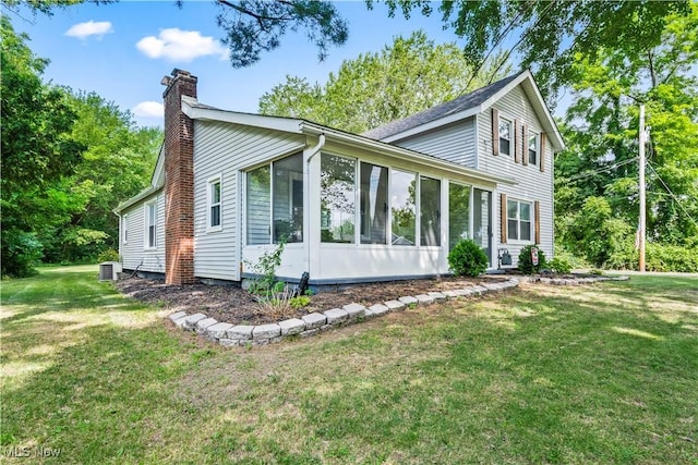 6170 Oberlin Rd, Amherst, OH 44001 - view of front facade featuring a chimney, a sunroom, and a front lawn