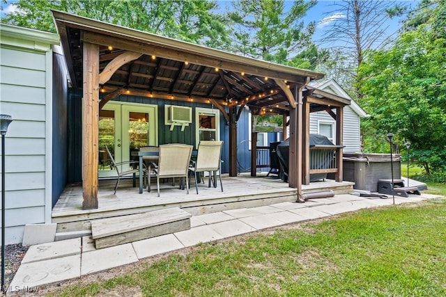 6170 Oberlin Rd, Amherst, OH 44001 - view of patio featuring a hot tub, a deck, a wall unit AC, outdoor dining area, and a grill