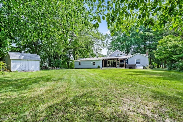 6170 Oberlin Rd, Amherst, OH 44001 - view of green lawn with a sunroom and a storage unit