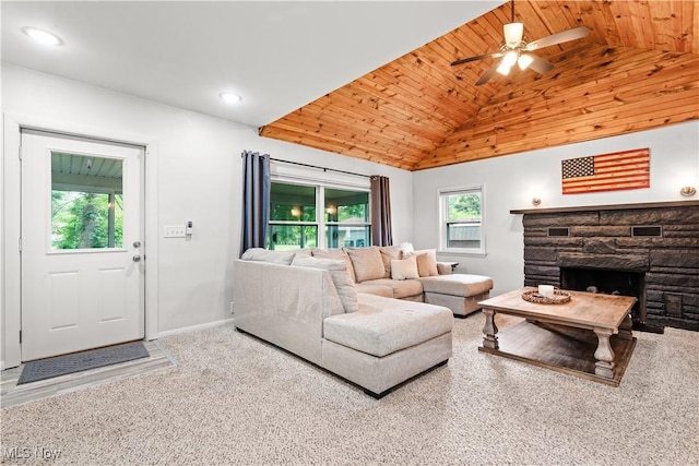 6170 Oberlin Rd, Amherst, OH 44001 - carpeted living room featuring lofted ceiling, wood ceiling, a ceiling fan, a stone fireplace, and recessed lighting
