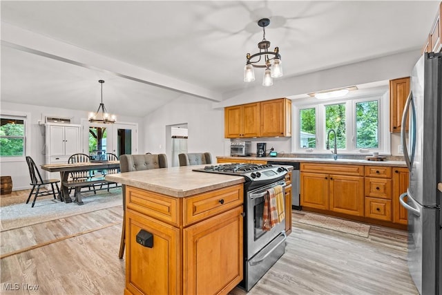 6170 Oberlin Rd, Amherst, OH 44001 - kitchen with stainless steel appliances, a chandelier, light countertops, and healthy amount of natural light