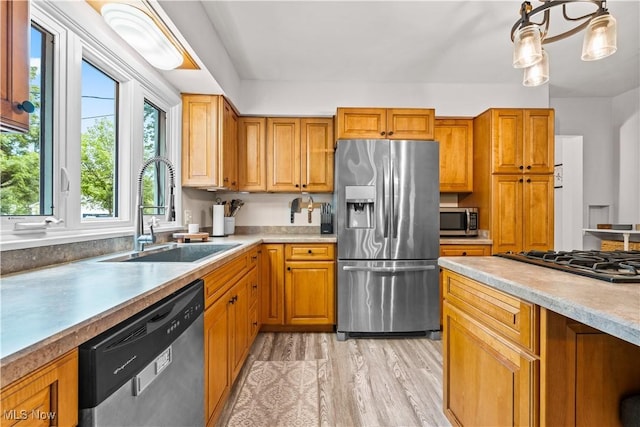 6170 Oberlin Rd, Amherst, OH 44001 - kitchen featuring stainless steel appliances, light wood-style flooring, brown cabinets, and light countertops