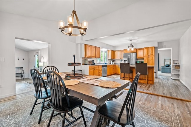 6170 Oberlin Rd, Amherst, OH 44001 - dining room with light wood-style flooring, a chandelier, and healthy amount of natural light