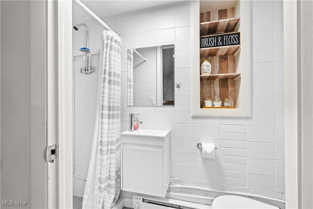 6170 Oberlin Rd, Amherst, OH 44001 - full bathroom featuring tile walls, vanity, and curtained shower