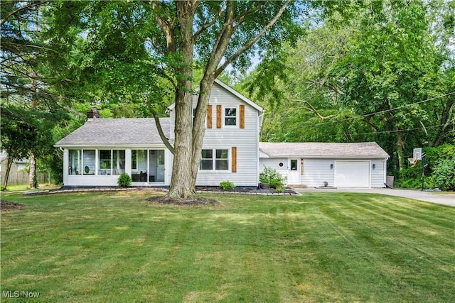 6170 Oberlin Rd, Amherst, OH 44001 - view of front of house featuring an attached garage, driveway, a front lawn, and a chimney