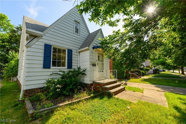 19005 Pawnee Ave, Cleveland, OH 44119 - bungalow with a front lawn and a shingled roof