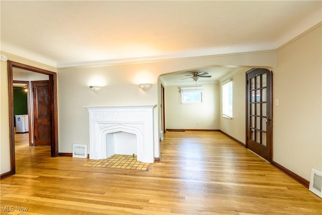 19005 Pawnee Ave, Cleveland, OH 44119 - unfurnished living room with arched walkways, ceiling fan, light wood-type flooring, and crown molding