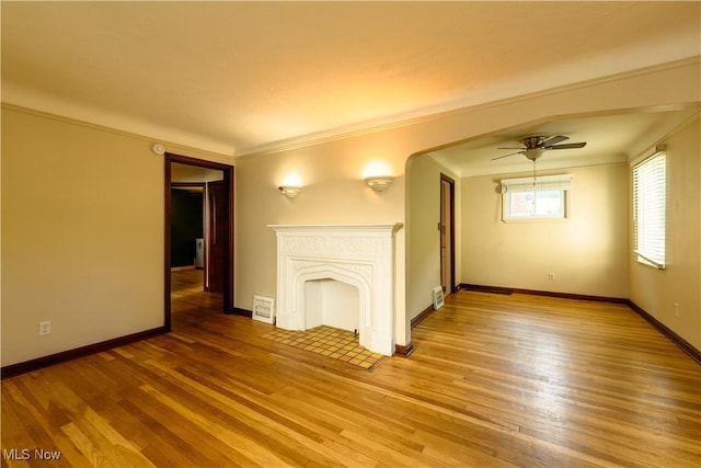 19005 Pawnee Ave, Cleveland, OH 44119 - unfurnished living room featuring light wood-style flooring, ceiling fan, and crown molding