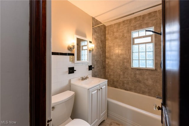 19005 Pawnee Ave, Cleveland, OH 44119 - bathroom featuring vanity, bathtub / shower combination, and tile walls