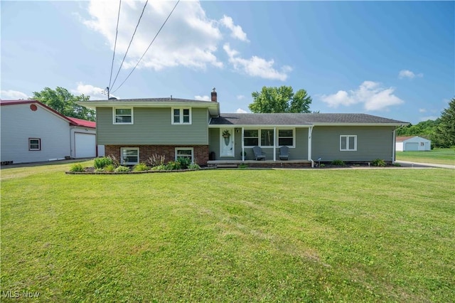 2835 Hallock Young Rd SW, Warren, OH 44481 - tri-level home featuring a porch, a front yard, a chimney, and brick siding