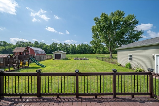 2835 Hallock Young Rd SW, Warren, OH 44481 - wooden terrace featuring a fenced backyard, a playground, and a storage shed