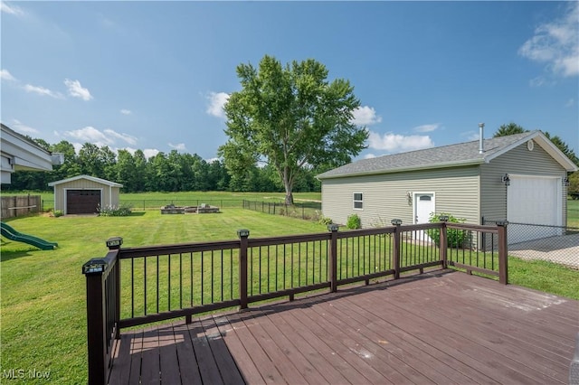 2835 Hallock Young Rd SW, Warren, OH 44481 - wooden deck featuring an outbuilding, a fenced backyard, a fire pit, and a garage