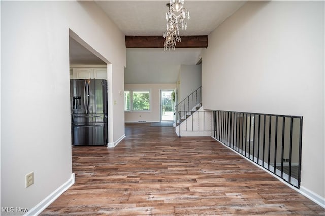2835 Hallock Young Rd SW, Warren, OH 44481 - hallway with wood finished floors, a chandelier, and stairs