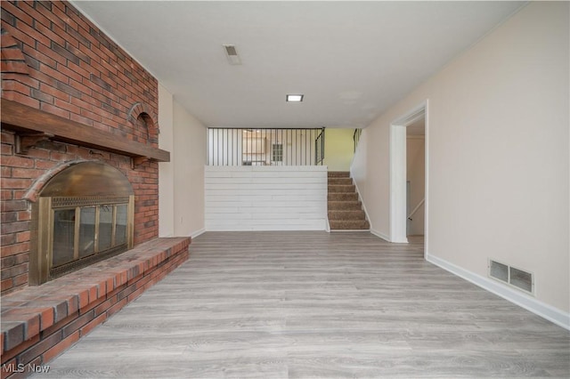 2835 Hallock Young Rd SW, Warren, OH 44481 - unfurnished living room with wood finished floors, stairs, and a fireplace