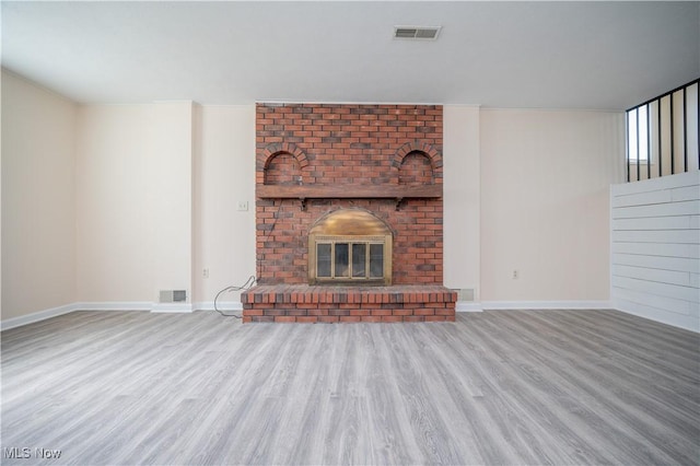 2835 Hallock Young Rd SW, Warren, OH 44481 - unfurnished living room featuring wood finished floors and a brick fireplace