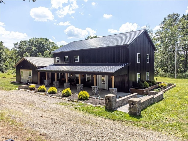 10770 W W Salem Rd, West Salem, OH 44287 - view of front of home featuring a metal roof, a porch, a front yard, and board and batten siding