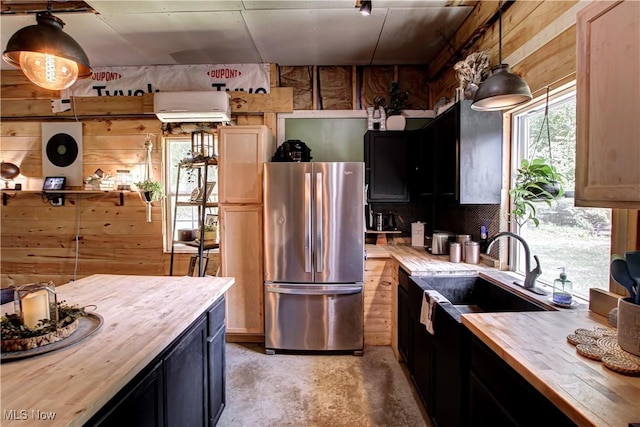 10770 W W Salem Rd, West Salem, OH 44287 - kitchen with freestanding refrigerator, wood counters, wooden walls, concrete flooring, and a wall mounted air conditioner