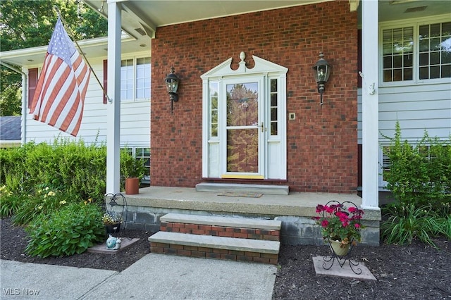 2948 Robin Hill Ln, Mogadore, OH 44260 - view of exterior entry with a porch and brick siding