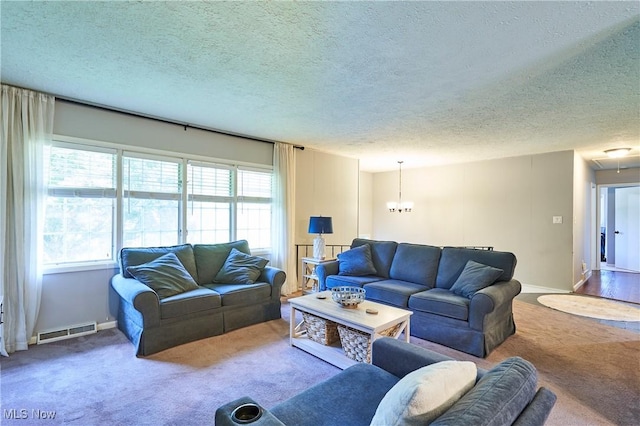 2948 Robin Hill Ln, Mogadore, OH 44260 - carpeted living area with a textured ceiling and a chandelier