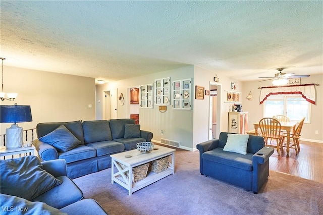 2948 Robin Hill Ln, Mogadore, OH 44260 - carpeted living area with a textured ceiling, a chandelier, and a ceiling fan