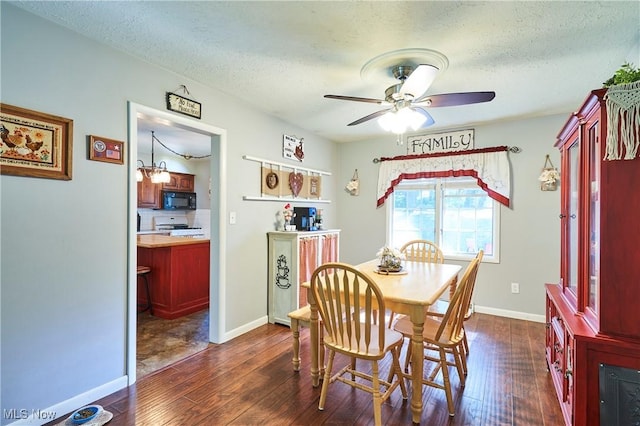 2948 Robin Hill Ln, Mogadore, OH 44260 - dining area featuring dark wood-type flooring, ceiling fan, and a textured ceiling