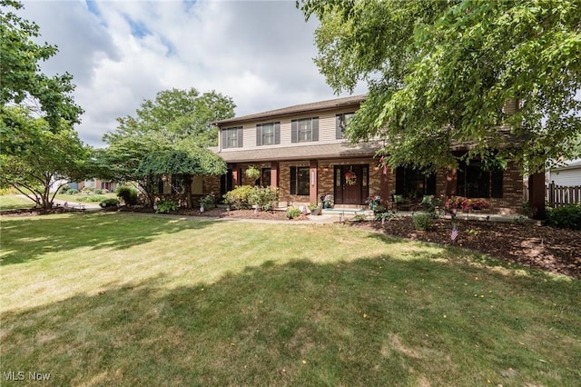6252 Pebblebrook Ln, North Olmsted, OH 44070 - view of front of home featuring a porch, a front lawn, and brick siding
